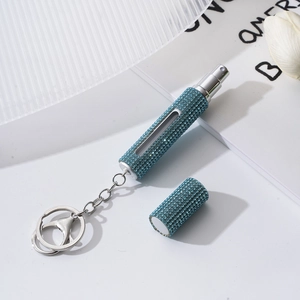 Detail of blue rhinestone refillable perfume bottle with a portable keychain