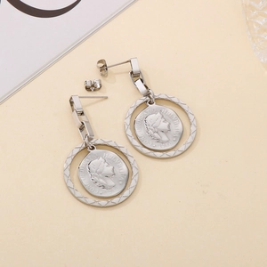 Macro detail of silver coin earrings with portrait embossing and rectangular chain links