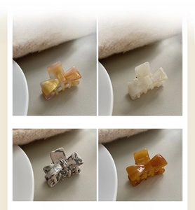 Collage of acetate bow hair claws in iridescent, pearly, marble, and amber finishes