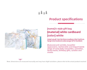 Macro detail of white marble paper gift bags showing ribbon bows and size specifications