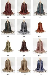 Detailed catalog showing 12 color options of ethnic paisley scarves with tassel fringe