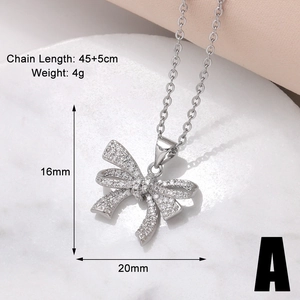 Macro detail of silver bow pendant with zircon inlays and precise dimensions