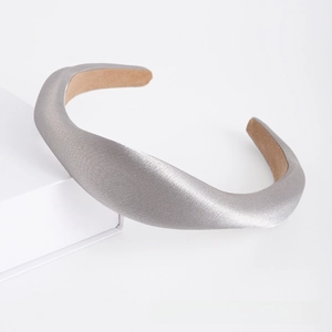 Close-up of silver-gray padded satin headband featuring a thick high-top design