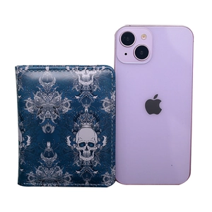 Blue skull and vine pattern short wallet shown next to a smartphone for size reference