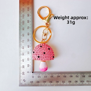Detailed view of mushroom keychain with pink rhinestones and scale ruler showing 110mm length