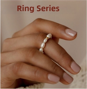 Minimalist ring with white freshwater pearls and a single 18k gold bead on model