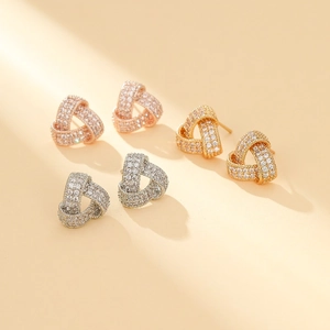 Detailed macro view of S925 snowflake earrings set with zircons in gold and rose gold