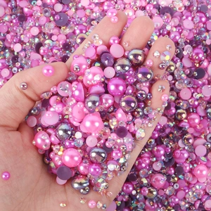 Close-up of pink and purple pearls mixed with iridescent rhinestones for DIY nail art