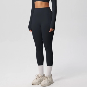 Detail of high waisted yoga leggings with functional side pockets and elastic black fabric