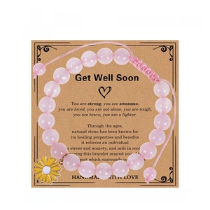 Adjustable pink crystal bead bracelet with enamel sunflower charm on a gift card