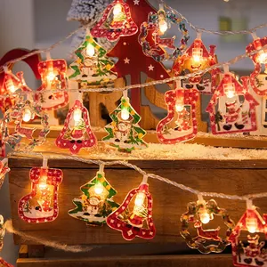 Christmas LED string lights with bell tree and sock pendants in warm white light