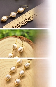 Macro detail of handmade 18K gold wire-wrapped earrings with three freshwater pearls