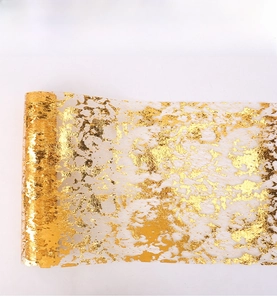 Close-up of gold foil mesh fabric roll showing glittering metallic texture and net pattern