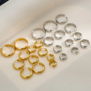 Polished gold and silver titanium steel hoop earrings in various sizes for women
