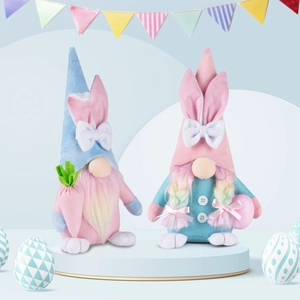 Detail of plush Easter gnomes with rabbit ears holding carrot and colorful egg ornament
