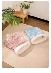 Plush pet sleeping bags in pink and blue floral prints with warm white fleece lining