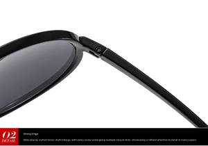 Detailed close-up of reinforced screw hinge and polished frame on black oversized sunglasses