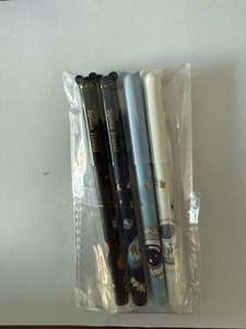 Close-up of four astronaut themed erasable gel pens in retail plastic packaging