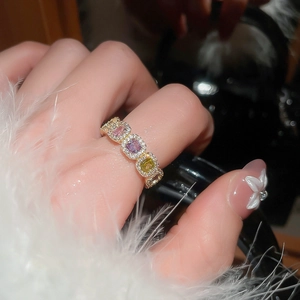 Macro view of a 14k gold plated ring featuring colorful square zircon stones and crystals