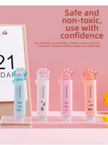 Detailed view of cat paw sliding erasers in blue, white and pink on a cute desk setup