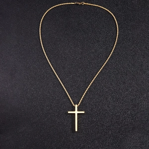 Close-up of golden cross pendant with twisted rope chain on a textured black background
