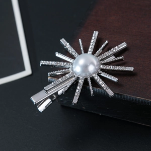 Sparkling sunflower hair clip with a large pearl center and rhinestones on silver metal