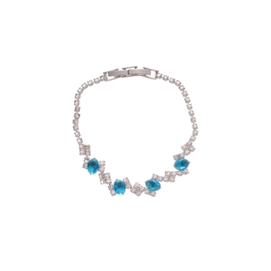 Sparkling silver bangle featuring oval blue stones and square cubic zirconia accents