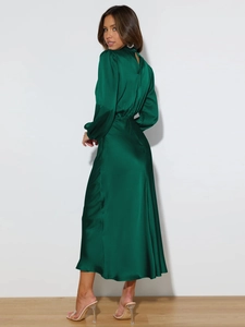 Elegant emerald green satin halter dress with long sleeves and pleated mock neck design