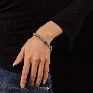 Detail of tiger eye stone bracelet on wrist with silver stainless steel accents