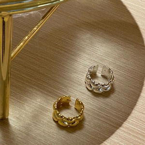 Minimalist double-layered gold and silver bubble rings on a natural wood surface