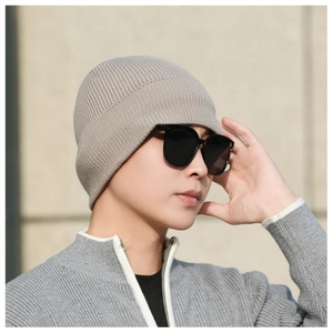 Close-up of the light coffee knitted beanie texture and fine vertical stripe ribbing detail