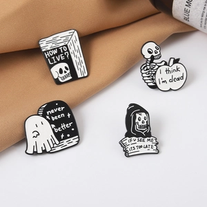 Gothic skull enamel pins collection with dark humor quotes on textured fabric background