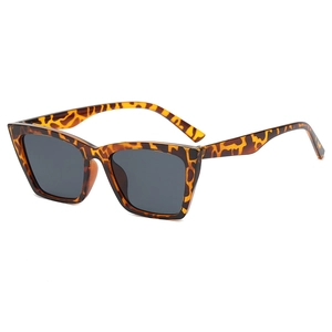 Fashionable cat eye sunglasses with tortoise shell frame and dark grey lenses on white background