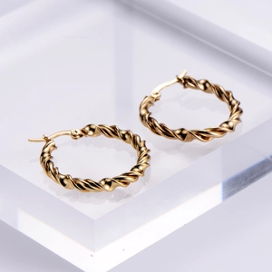 Elegant gold twisted hoop earrings with a polished metal texture for women