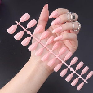 Close-up of 24pcs glossy pink almond press-on nails set displayed on a plastic sheet