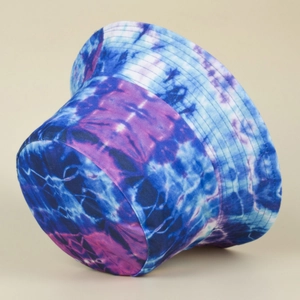 Detail view of starry tie-dye bucket hat fabric texture with blue and purple patterns