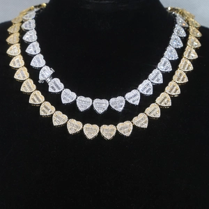 Detail of heart-shaped link chain necklaces with pavé zircon in gold and silver finish
