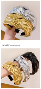 Detailed macro view of metallic PU fabric texture on a wide knotted fashion headband