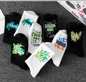 Graffiti printed crew socks in black and white cotton with street style patterns