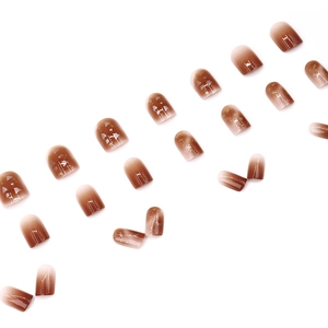 Short square press-on nails with amber brown gradient and gold foil accents