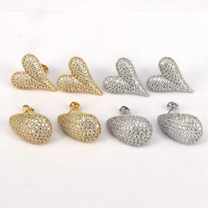 Macro detail of sparkling heart and teardrop stud earrings with micro-pave zirconia crystals