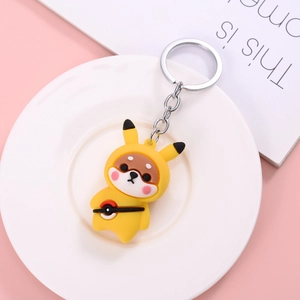 Cute Shiba Inu plush keychain in yellow Pikachu outfit on a white porcelain plate