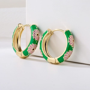 Green enamel hoop earrings with pink daisy floral pattern and gold plated finish