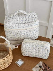 Two-piece floral quilted toiletry bag set in light blue flowers with bow details