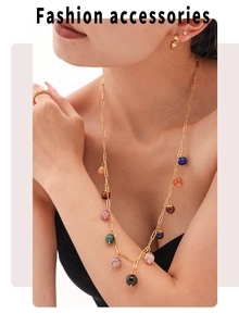 Detail shot of a bohemian colorful stone necklace with matching gold earrings and ring