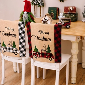 Christmas chair covers featuring buffalo plaid trucks and Merry Christmas text on linen