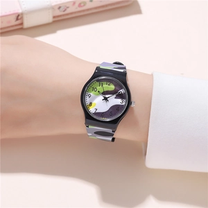 Close-up of camouflage quartz watch on wrist showing clear Arabic numerals and purple pattern