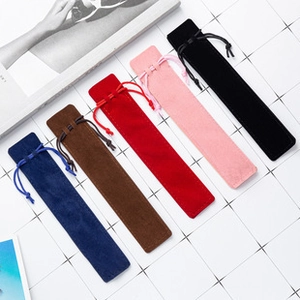 Detailed close-up of velvet pen pouches in navy, brown, red, pink, and black colors