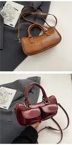 Close-up of vintage saddle bags with glossy finish, dual front pockets and silver hardware