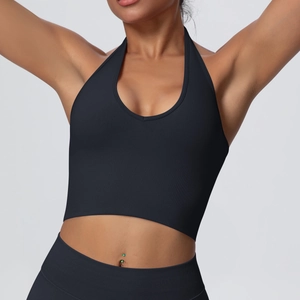 Close-up of black halter neck yoga bra showing seamless ribbed fabric texture and deep V-neck